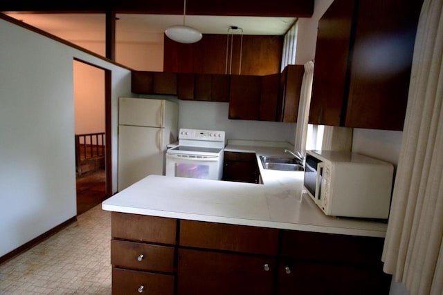 6202 Piping Rock Rd, Madison, WI 53711 - kitchen featuring white appliances, light countertops, a peninsula, and dark brown cabinets