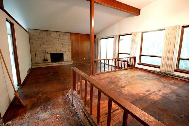 6202 Piping Rock Rd, Madison, WI 53711 - unfurnished living room featuring healthy amount of natural light, a stone fireplace, and baseboard heating
