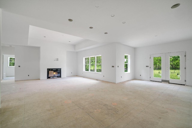 LT3 E Miramar Dr, East Troy, WI 53120 - unfurnished living room featuring a glass covered fireplace and light carpet