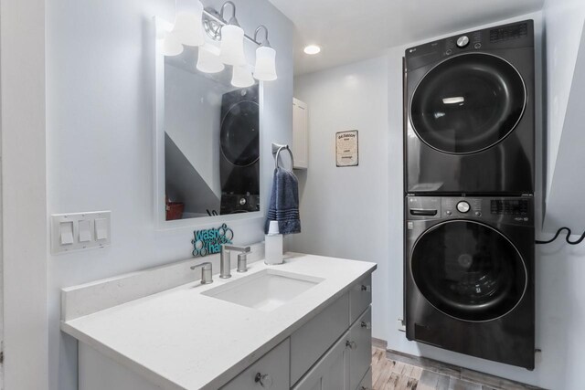 1133 Racine St, Delavan, WI 53115 - laundry area featuring stacked washing machine and dryer, light wood-style floors, and recessed lighting