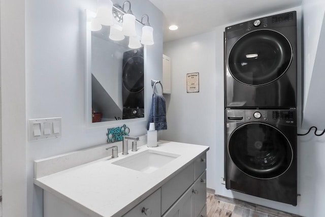 1133 Racine St, Delavan, WI 53115 - laundry area featuring stacked washing machine and dryer, light wood-style floors, and recessed lighting