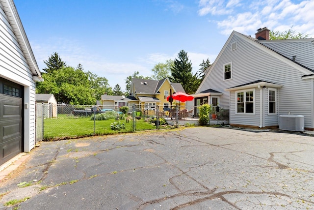 1133 Racine St, Delavan, WI 53115 - view of side of home featuring a chimney and asphalt driveway