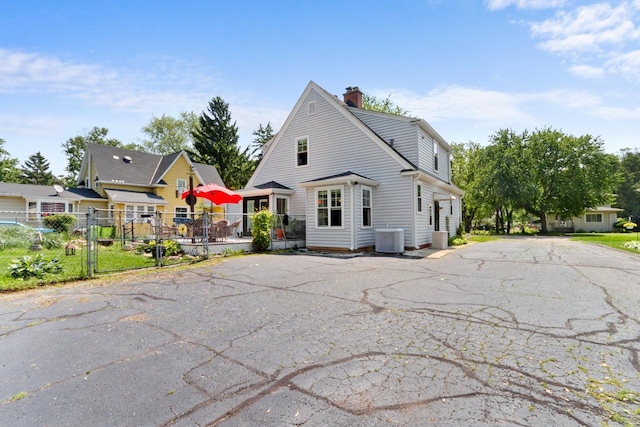 1133 Racine St, Delavan, WI 53115 - view of front of house with a chimney and a gate