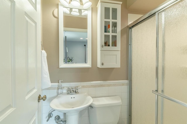 3472 Hickory Hill Rd, Verona, WI 53593 - bathroom featuring a wainscoted wall, a stall shower, and tile walls
