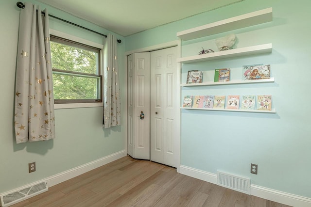 3472 Hickory Hill Rd, Verona, WI 53593 - unfurnished bedroom with wood finished floors and a closet