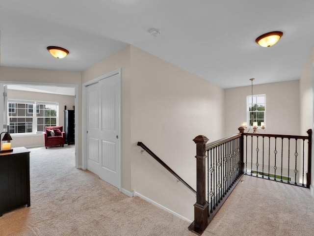 3605 Emmertsen Rd, Racine, WI 53406 - corridor featuring an upstairs landing, carpet, and a chandelier