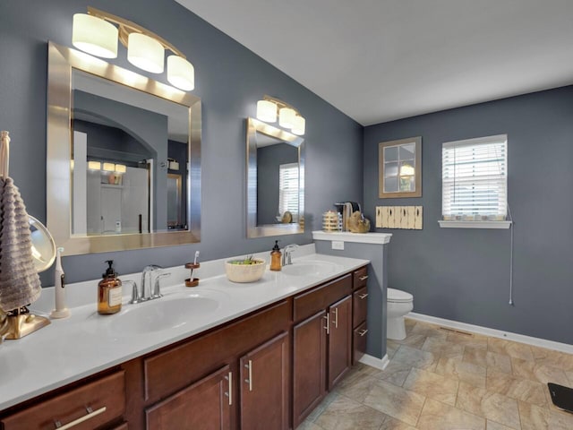 3605 Emmertsen Rd, Racine, WI 53406 - bathroom with double vanity, stone finish floors, and a shower