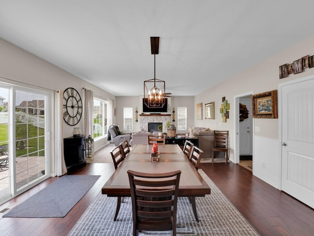 3605 Emmertsen Rd, Racine, WI 53406 - dining area featuring dark wood-type flooring and a stone fireplace