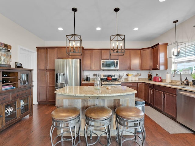 3605 Emmertsen Rd, Racine, WI 53406 - kitchen with stainless steel appliances, a chandelier, dark wood-type flooring, a kitchen island, and recessed lighting