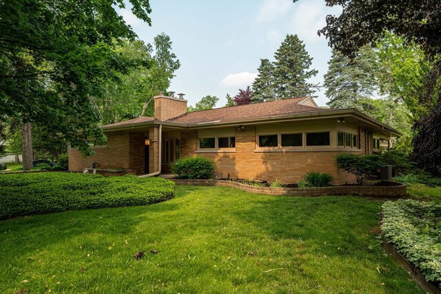 3358 Taylor Ave, Elmwood Park, WI 53405 - view of front of house with brick siding, a front yard, and a chimney