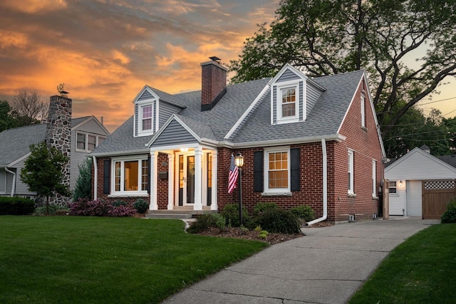 2461 N 94th St, Wauwatosa, WI 53226 - cape cod-style house with brick siding, an outdoor structure, a chimney, a yard, and roof with shingles