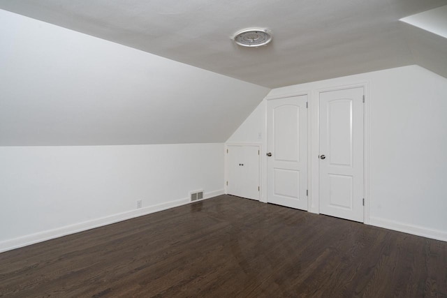2461 N 94th St, Wauwatosa, WI 53226 - additional living space featuring vaulted ceiling and dark wood-style flooring