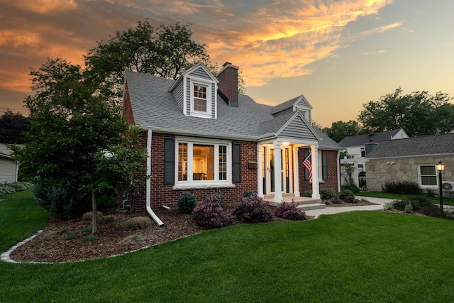 2461 N 94th St, Wauwatosa, WI 53226 - new england style home featuring a chimney, brick siding, a lawn, and roof with shingles