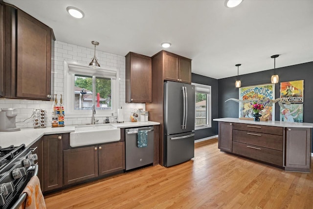 3351 W Vogel Ave, Greenfield, WI 53221 - kitchen featuring appliances with stainless steel finishes, backsplash, light wood-style flooring, dark brown cabinetry, and recessed lighting