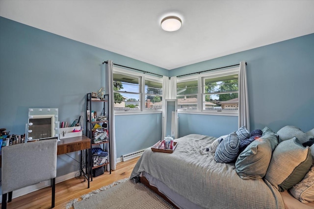 3351 W Vogel Ave, Greenfield, WI 53221 - bedroom with wood finished floors, multiple windows, baseboard heating, and a desk