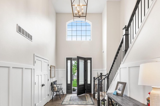 650 W Silverleaf Ct, Plover, WI 54467 - entrance foyer with a high ceiling, healthy amount of natural light, a chandelier, dark wood-type flooring, and stairway