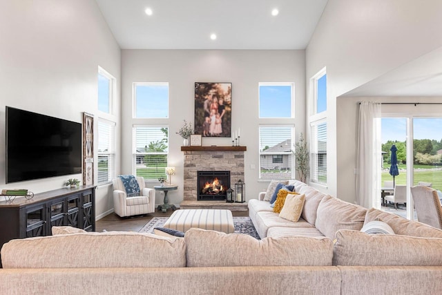650 W Silverleaf Ct, Plover, WI 54467 - living area with wood finished floors, a high ceiling, recessed lighting, and a fireplace