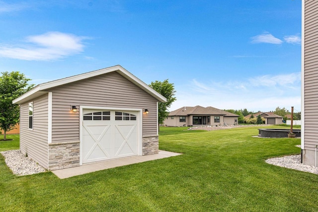 650 W Silverleaf Ct, Plover, WI 54467 - view of green lawn featuring a garage and an outbuilding