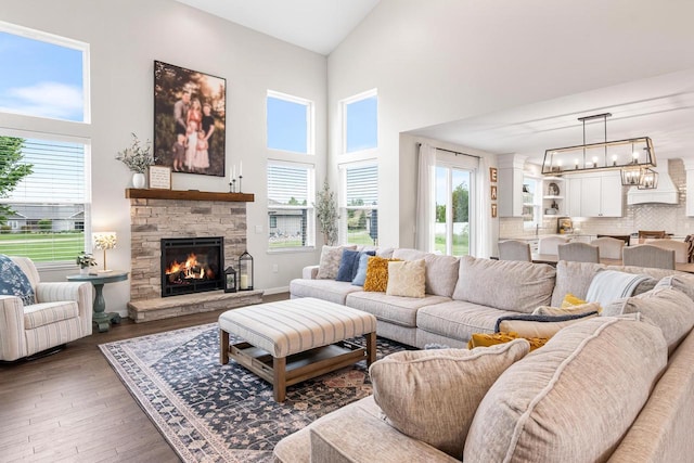 650 W Silverleaf Ct, Plover, WI 54467 - living room featuring high vaulted ceiling, plenty of natural light, a fireplace, hardwood / wood-style floors, and a chandelier