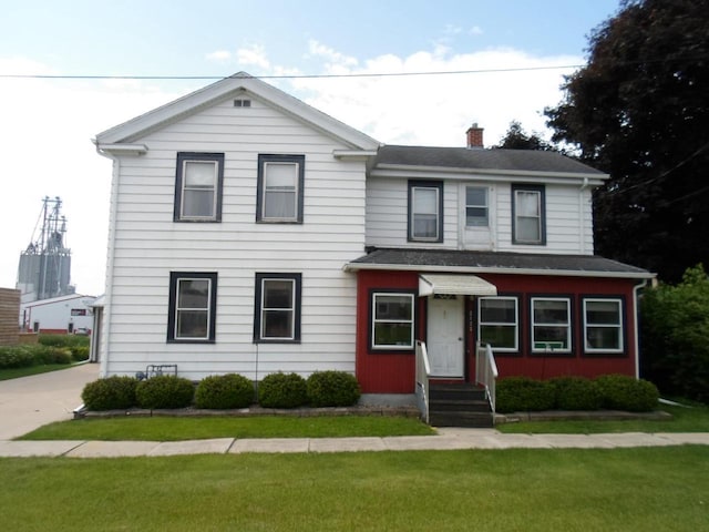 212 E Bowen St, Brandon, WI 53919 - view of front facade with entry steps, a chimney, and a front yard