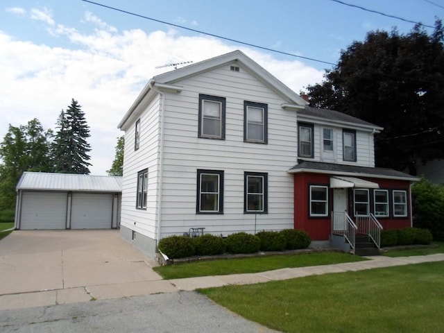 212 E Bowen St, Brandon, WI 53919 - traditional home with an outbuilding, a detached garage, and a front lawn