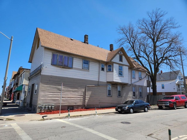 1535 W Lincoln Ave, Milwaukee, WI 53215 - view of side of home with crawl space, a residential view, and a chimney