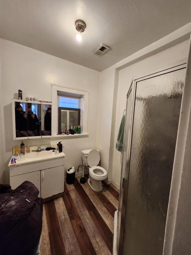 1535 W Lincoln Ave, Milwaukee, WI 53215 - bathroom with wood finished floors, vanity, and a stall shower