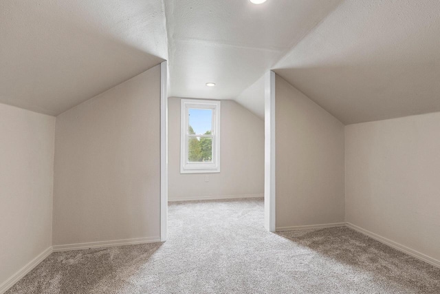 2717 13th St, Two Rivers, WI 54241 - bonus room featuring carpet floors, lofted ceiling, and a textured ceiling