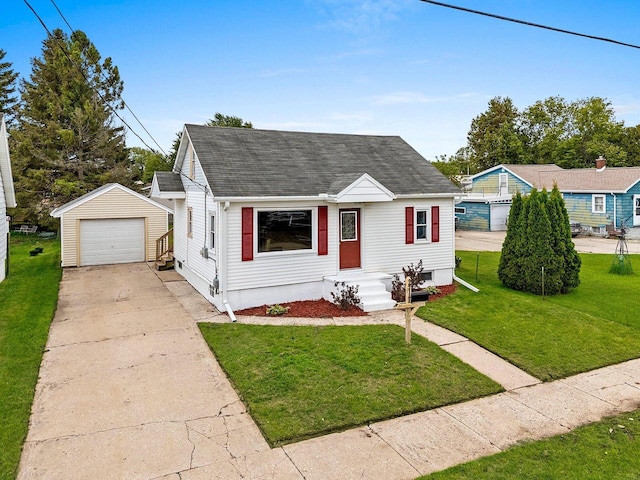 2717 13th St, Two Rivers, WI 54241 - view of front of property featuring an outbuilding, a detached garage, driveway, a shingled roof, and a front yard