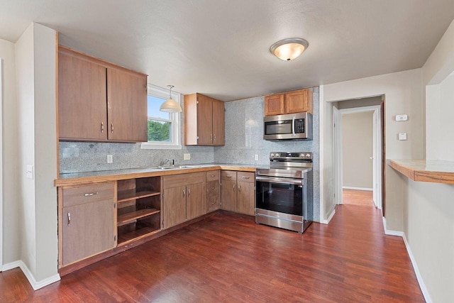 2717 13th St, Two Rivers, WI 54241 - kitchen with stainless steel appliances, decorative backsplash, dark wood-style floors, and light countertops