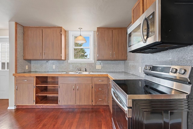 2717 13th St, Two Rivers, WI 54241 - kitchen featuring stainless steel appliances, dark wood-style floors, light countertops, and backsplash