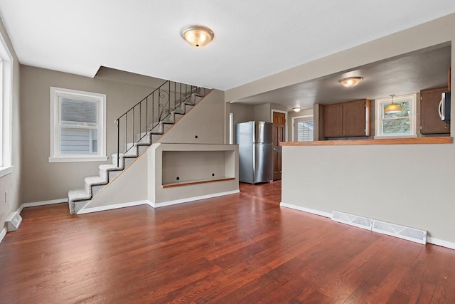 2717 13th St, Two Rivers, WI 54241 - unfurnished living room with dark wood finished floors and stairs