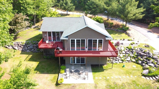 2783 High Peak Rd, Rhinelander, WI 54501 - back of house featuring a wooden deck, a patio, and a yard