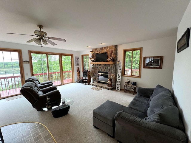 2783 High Peak Rd, Rhinelander, WI 54501 - living room with carpet flooring, plenty of natural light, ceiling fan, and a stone fireplace