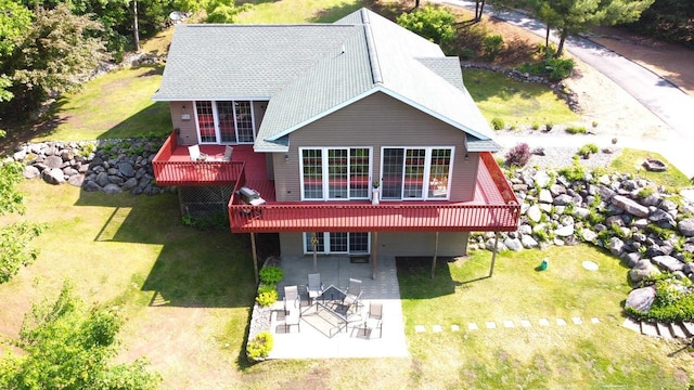 2783 High Peak Rd, Rhinelander, WI 54501 - back of property featuring a patio area, a wooden deck, a lawn, and roof with shingles