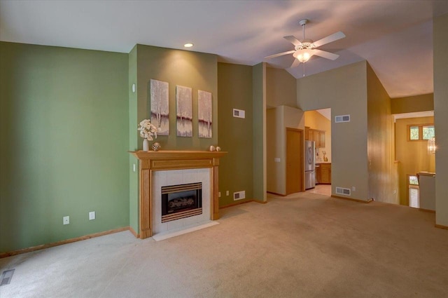 3 Deer Point Trl, Madison, WI 53719 - unfurnished living room featuring a ceiling fan, a tile fireplace, light carpet, and high vaulted ceiling