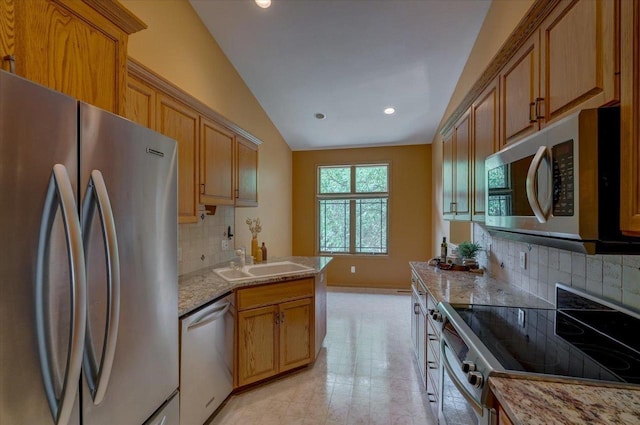 3 Deer Point Trl, Madison, WI 53719 - kitchen with appliances with stainless steel finishes, lofted ceiling, decorative backsplash, light stone countertops, and brown cabinetry