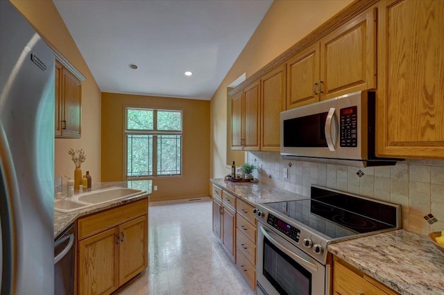 3 Deer Point Trl, Madison, WI 53719 - kitchen with appliances with stainless steel finishes, decorative backsplash, light stone counters, recessed lighting, and brown cabinets