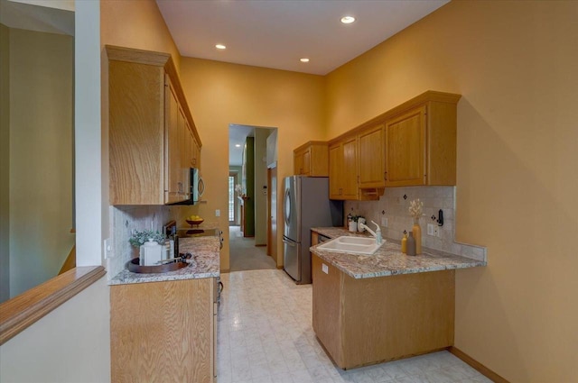 3 Deer Point Trl, Madison, WI 53719 - kitchen featuring stainless steel appliances, a peninsula, tasteful backsplash, recessed lighting, and light stone countertops