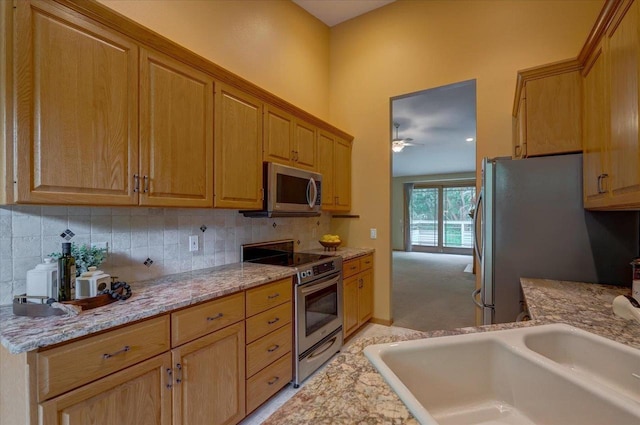 3 Deer Point Trl, Madison, WI 53719 - kitchen featuring stainless steel appliances, ceiling fan, tasteful backsplash, and light stone countertops