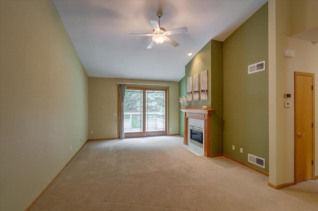 3 Deer Point Trl, Madison, WI 53719 - unfurnished living room featuring light carpet, a tile fireplace, ceiling fan, and lofted ceiling