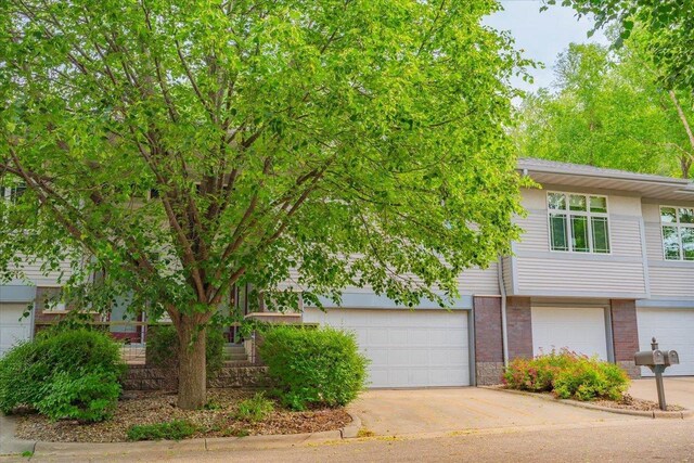 3 Deer Point Trl, Madison, WI 53719 - view of front facade with brick siding, concrete driveway, and an attached garage