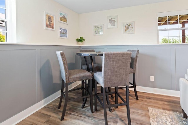1386 Overlook Cir, Hartland, WI 53029 - dining room with a decorative wall, wood finished floors, and a wainscoted wall