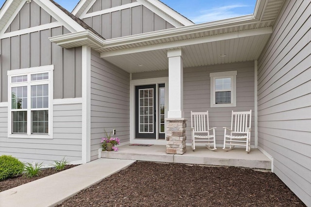 1386 Overlook Cir, Hartland, WI 53029 - view of exterior entry featuring board and batten siding and covered porch