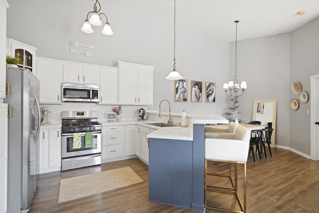 3223 55th Ct Unit 65, Kenosha, WI 53144 - kitchen with stainless steel appliances, high vaulted ceiling, a peninsula, tasteful backsplash, and a breakfast bar area