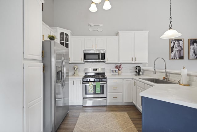 3223 55th Ct Unit 65, Kenosha, WI 53144 - kitchen featuring appliances with stainless steel finishes, white cabinets, tasteful backsplash, and dark wood-type flooring