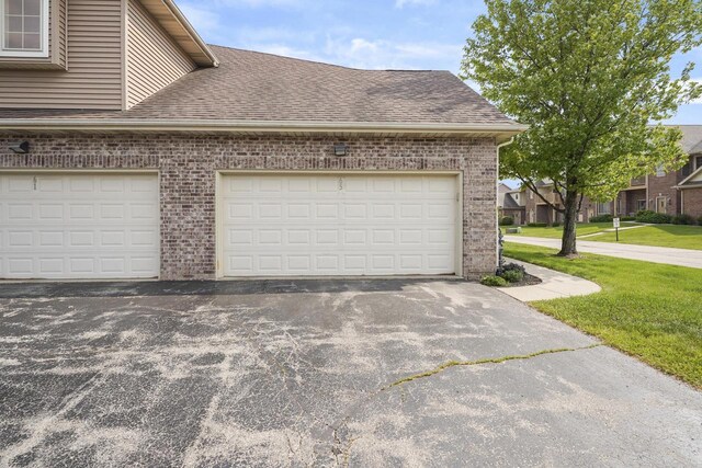 3223 55th Ct Unit 65, Kenosha, WI 53144 - garage featuring driveway