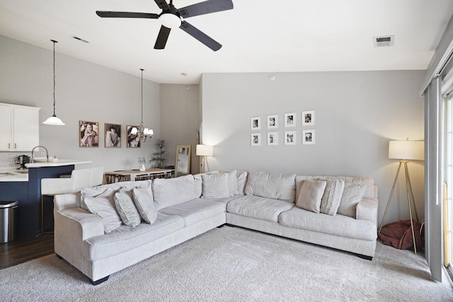 3223 55th Ct Unit 65, Kenosha, WI 53144 - living area featuring a ceiling fan, vaulted ceiling, a chandelier, and carpet flooring