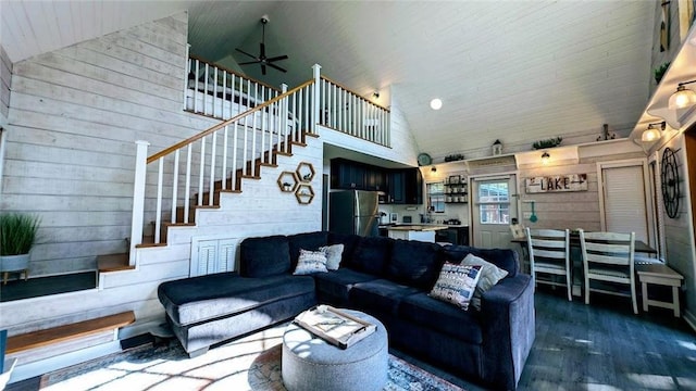 W6741 Lakewood Blvd, Ladysmith, WI 54848 - living area with high vaulted ceiling, stairway, dark wood finished floors, a ceiling fan, and wood walls