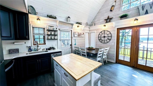 W6741 Lakewood Blvd, Ladysmith, WI 54848 - kitchen featuring high vaulted ceiling, plenty of natural light, dark wood finished floors, wooden walls, and dark cabinetry